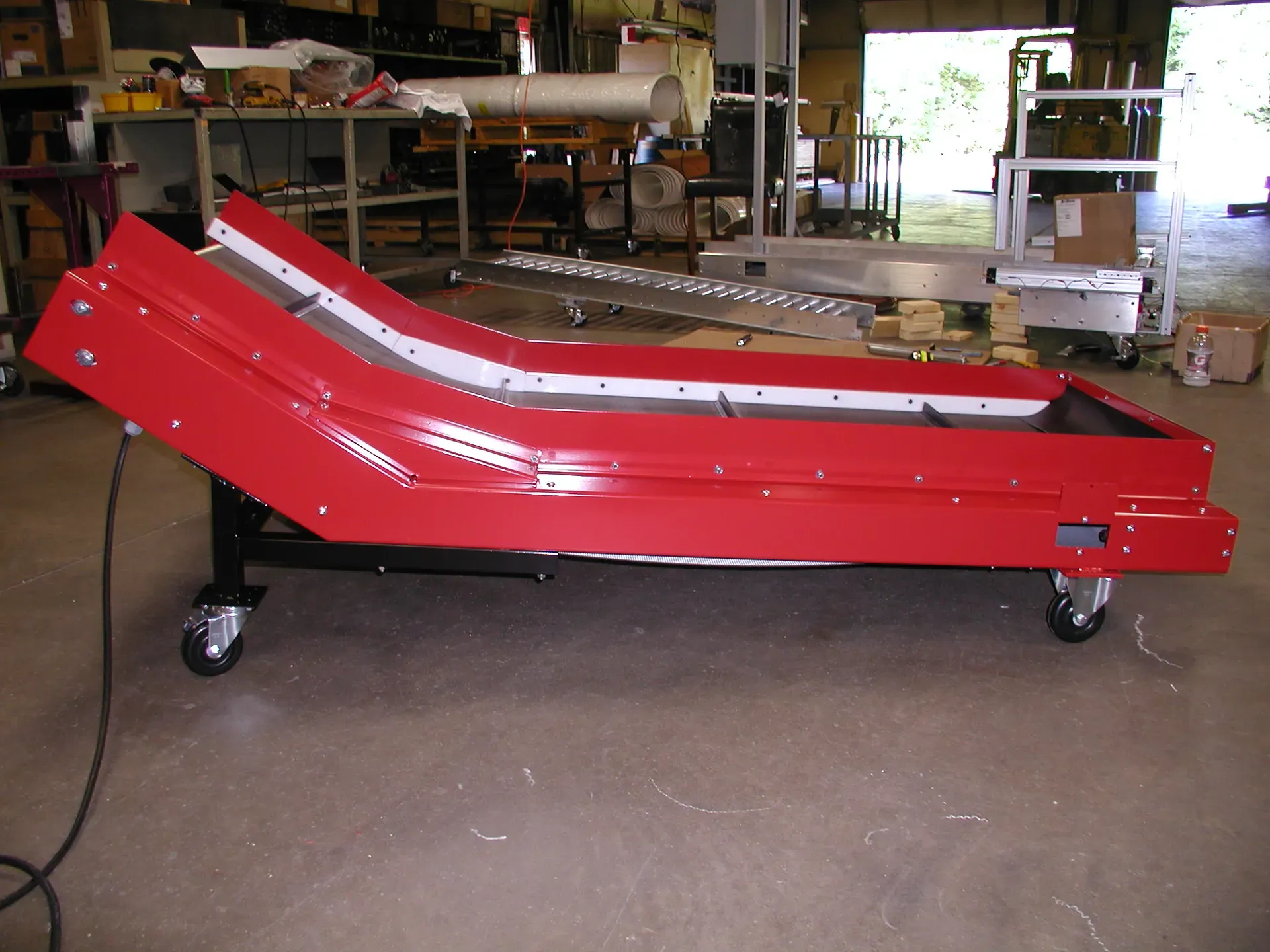 Red LaRos horizontal-to-incline conveyor on casters