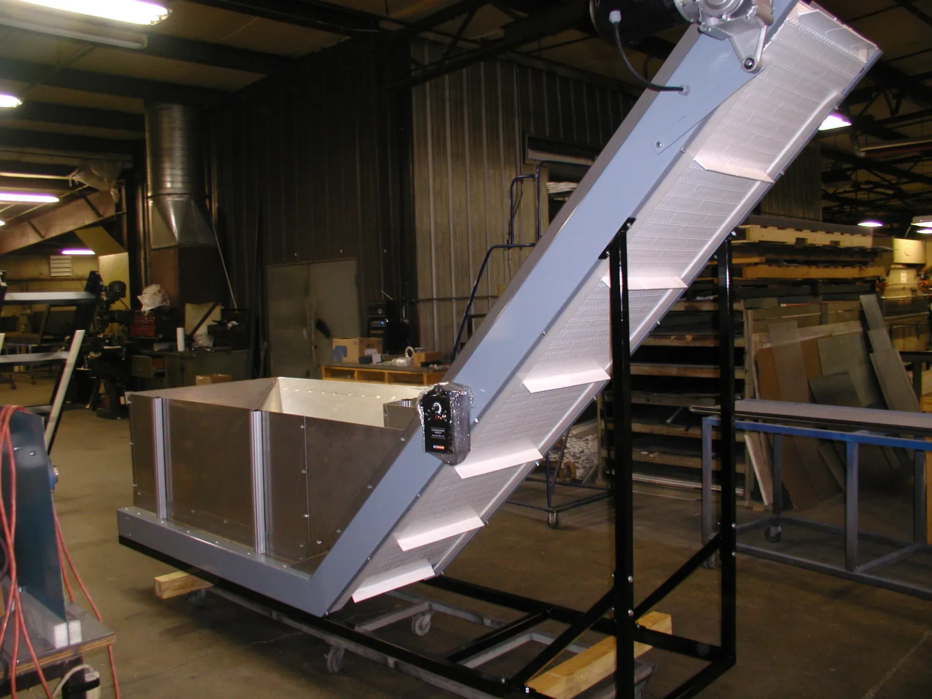 LaRos incline conveyor with stainless receiving hopper